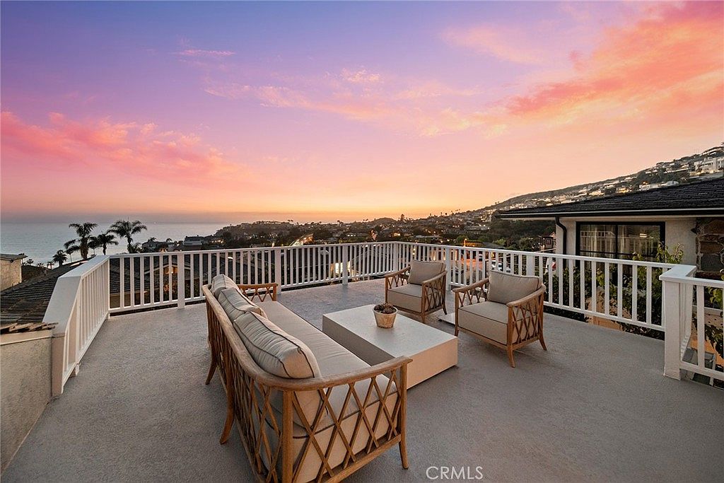 A pink coral sunset over the Pacific from the rooftop deck of 320 Emerald Bay