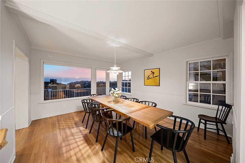 Dining room with windows facing the Pacific at dusk