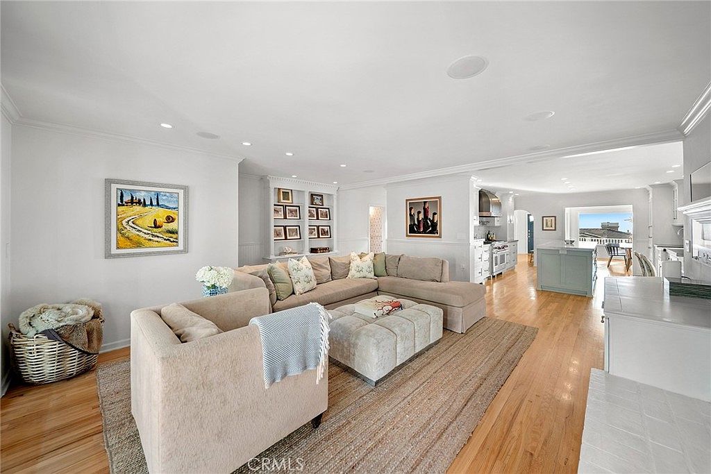 Open-plan great room with sectional and view through to kitchen and dining